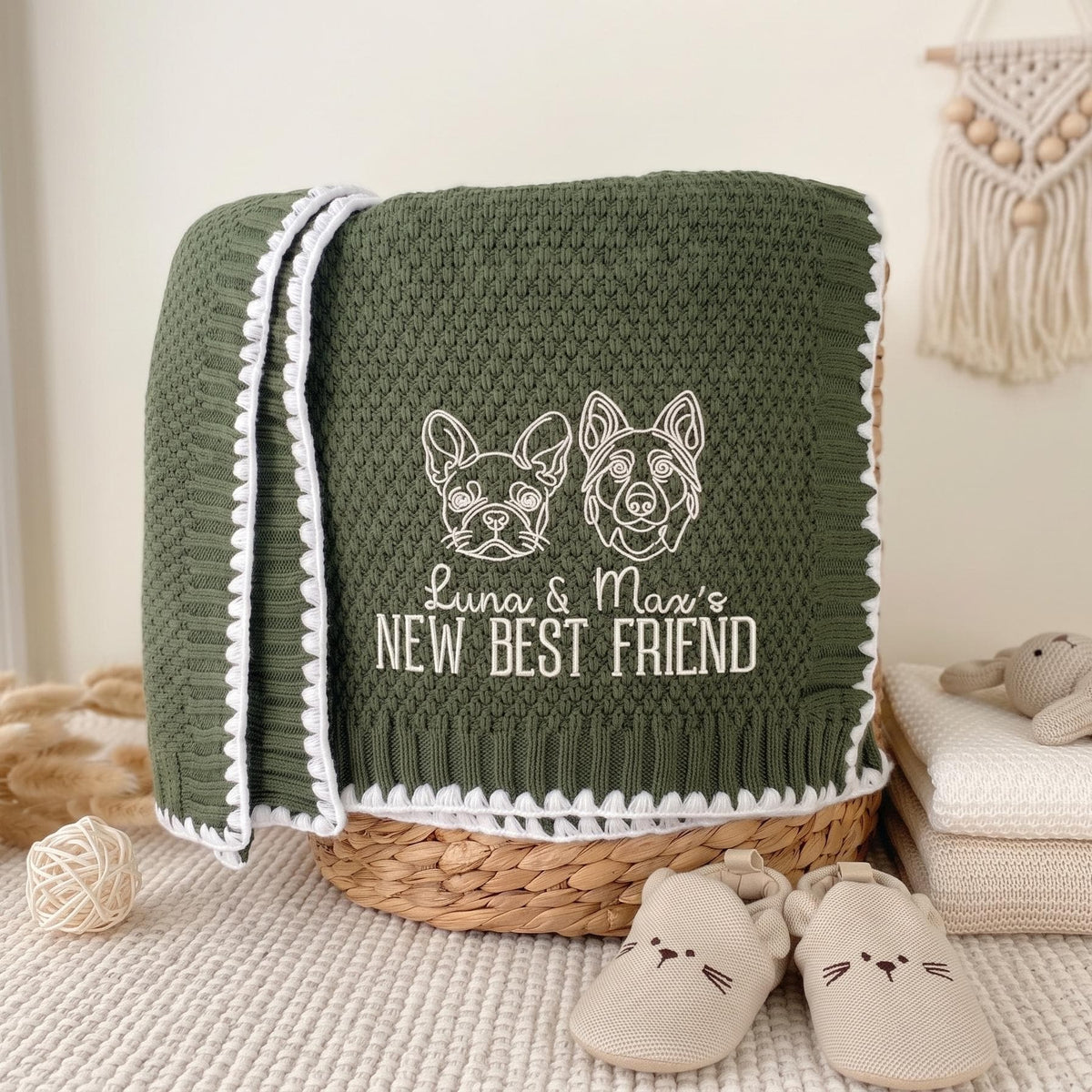 Olive personalized new best friend baby blanket with white embroidered dog, cat and pet names over a basket