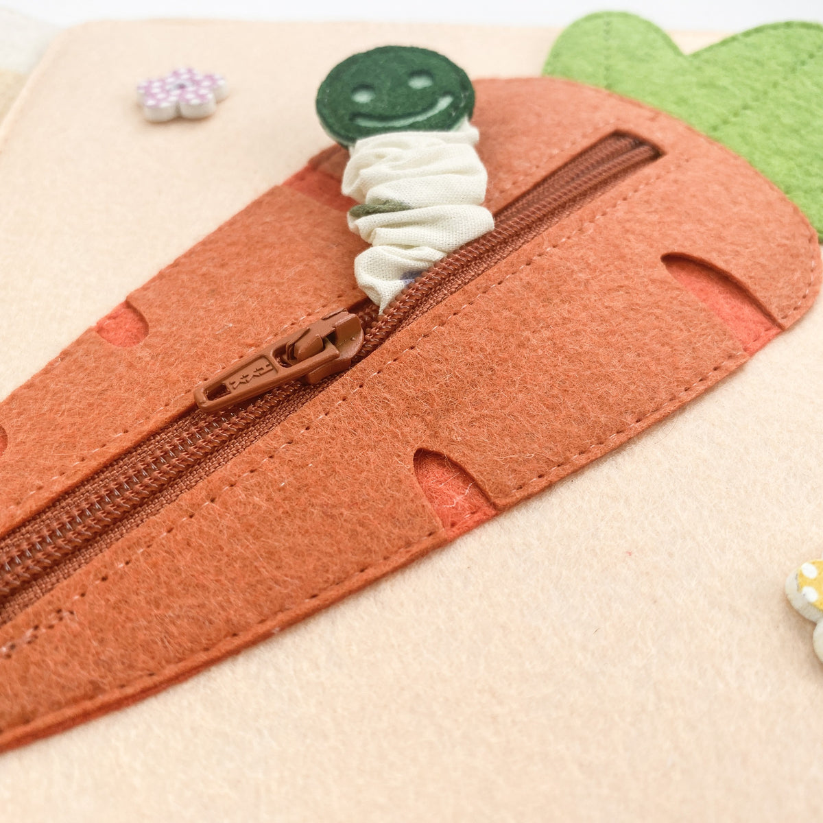 Felt carrot page with a zipper and hidden worm in a busy book