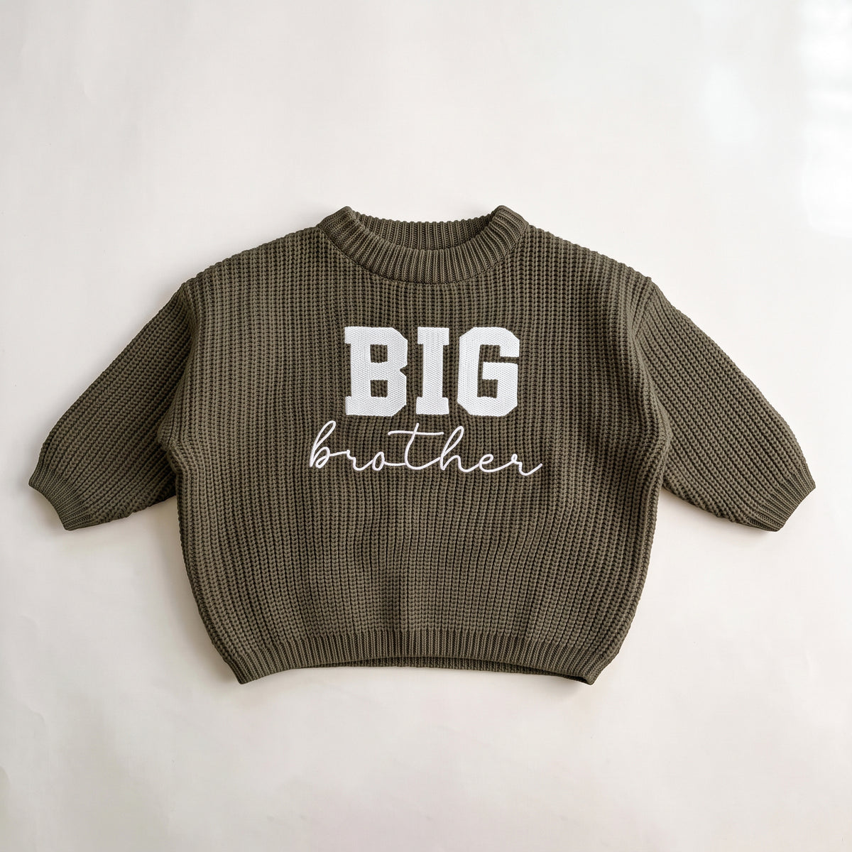Olive chunky knit baby sweater with BIG brother embroidery, laid flat