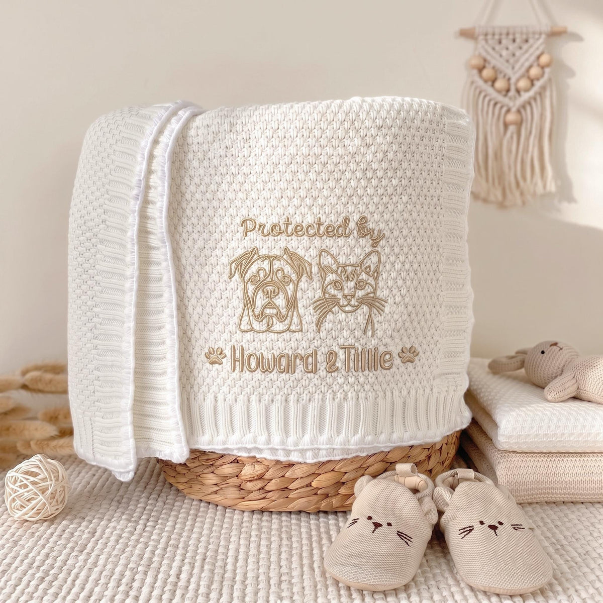 Personalized pet portrait baby blanket in white knit, embroidered dog and cat with "Protected by Howard & Tillie"