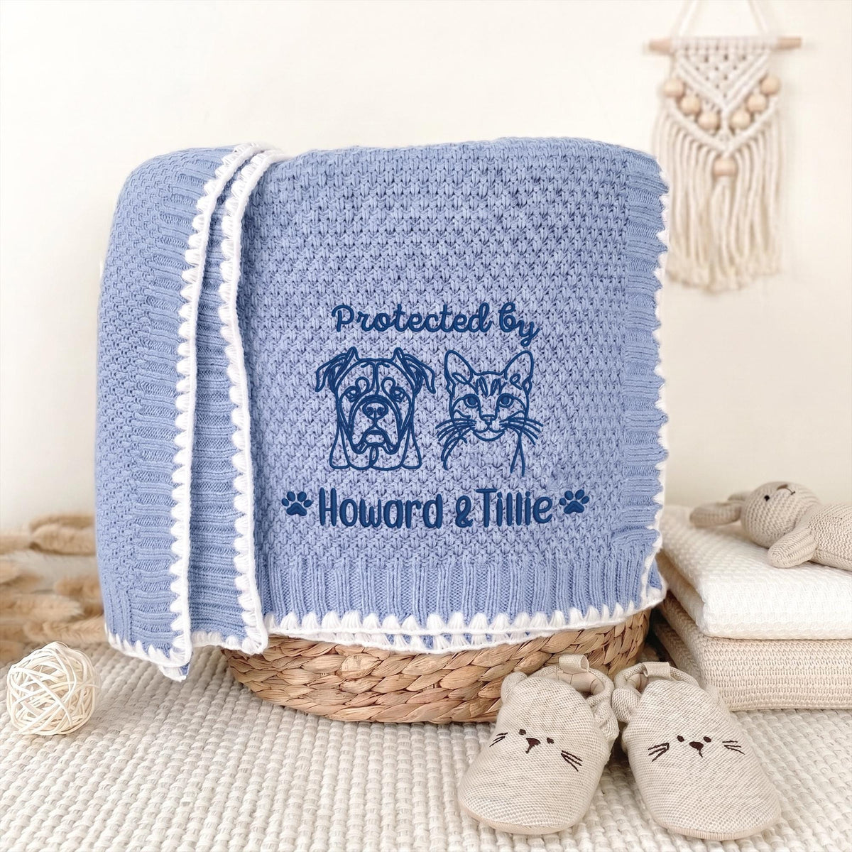 Blue personalized pet portrait baby blanket with navy embroidered dog, cat and pet names