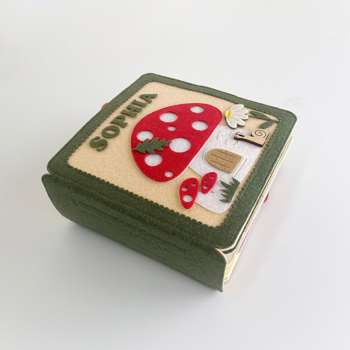 Personalized mushroom fairy garden felt busy book with embroidered name Sophia, angled view