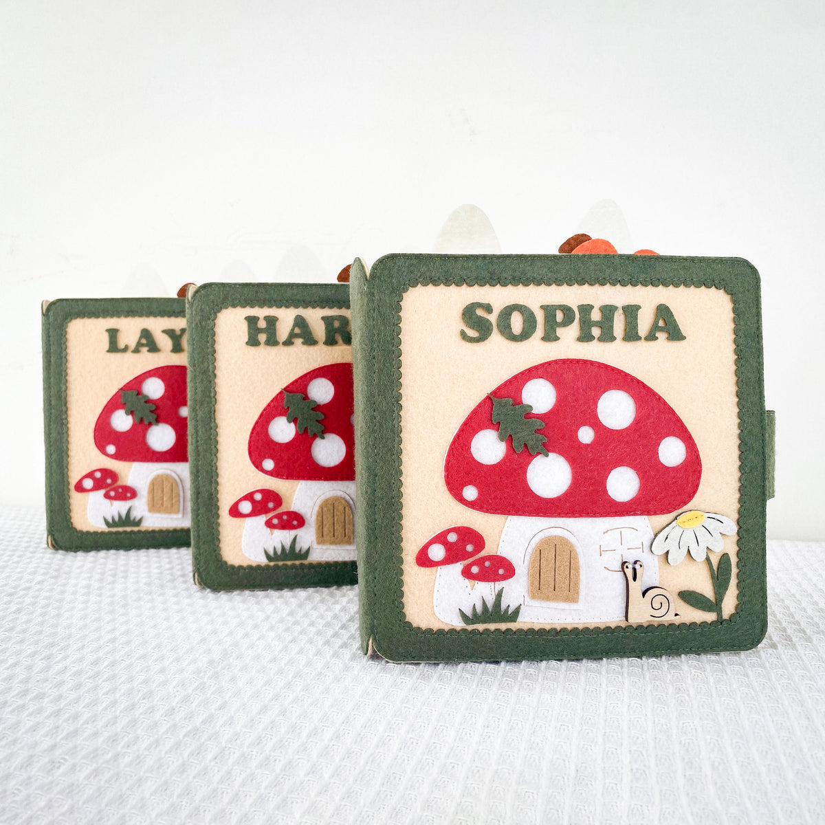 Three personalized fairy garden felt quiet books with different names