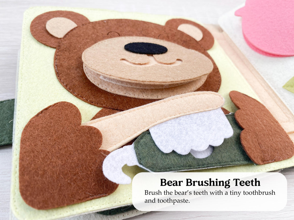 Felt bear brushing teeth page with a toothbrush in a busy book
