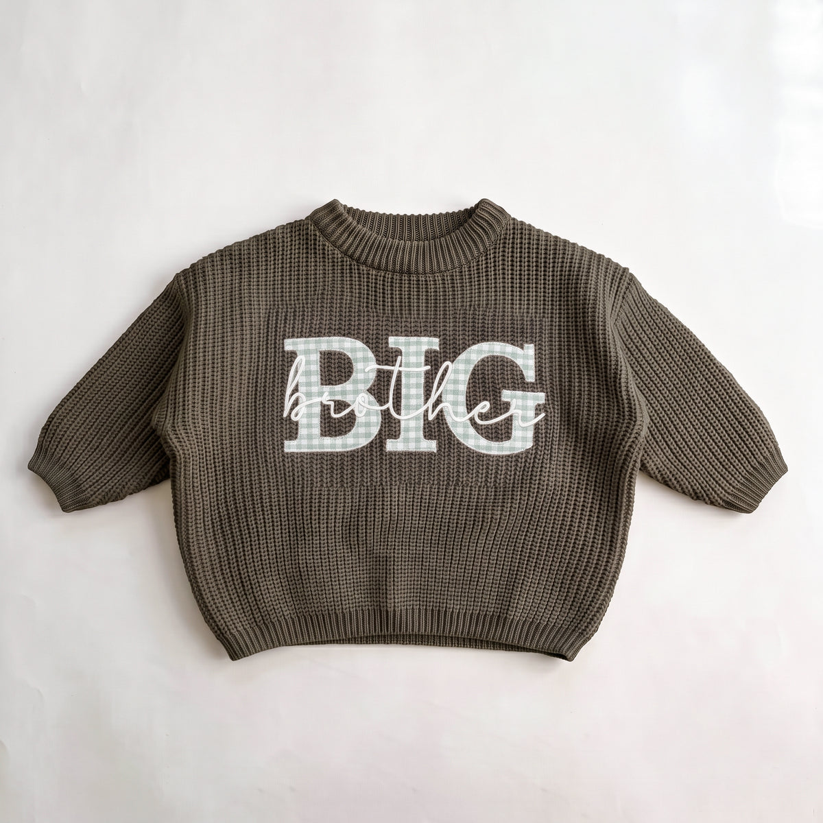 Olive knit sweater with light gingham BIG applique letters and brother embroidered in white script, laid flat