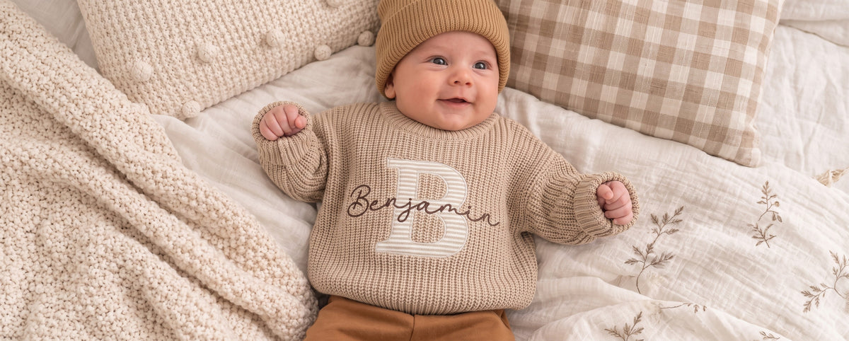 Baby wearing a personalized embroidered name sweater - Chiccubs